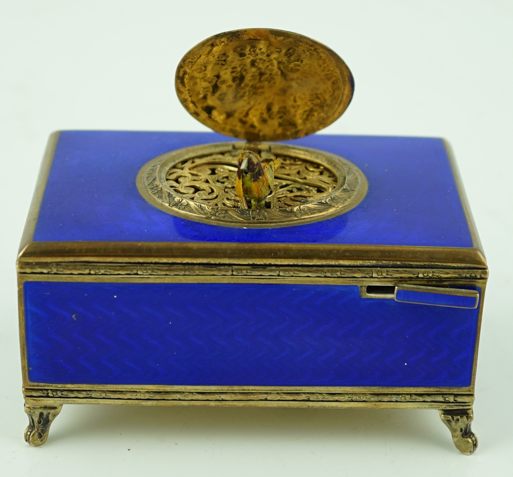 An early 20th century sterling silver gilt and blue guilloche enamelled rectangular singing bird box